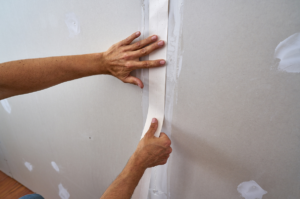 Image of someone repairing a wall